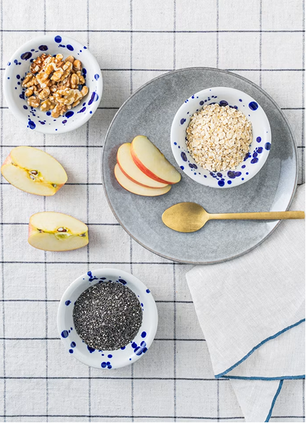 Overhead flat lay with oats, apples, and chia seeds